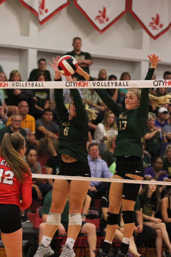 Rylee Fay '20 and Claire Overton '19 block the ball during the third set of the game on Tuesday, Aug. 21.