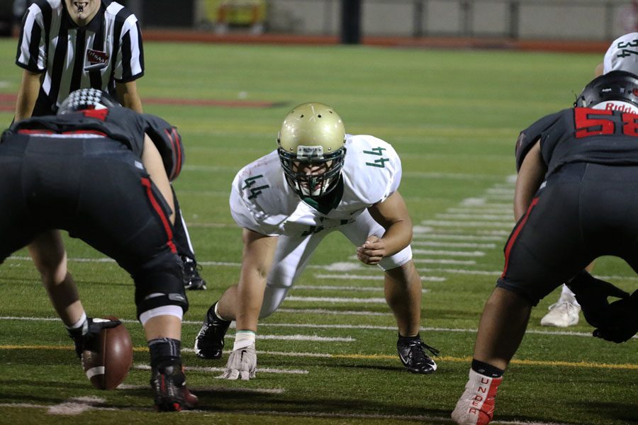 Landon Green '19 waits for Linn-Mar to hike the ball during the second half on Friday, Sept. 28.