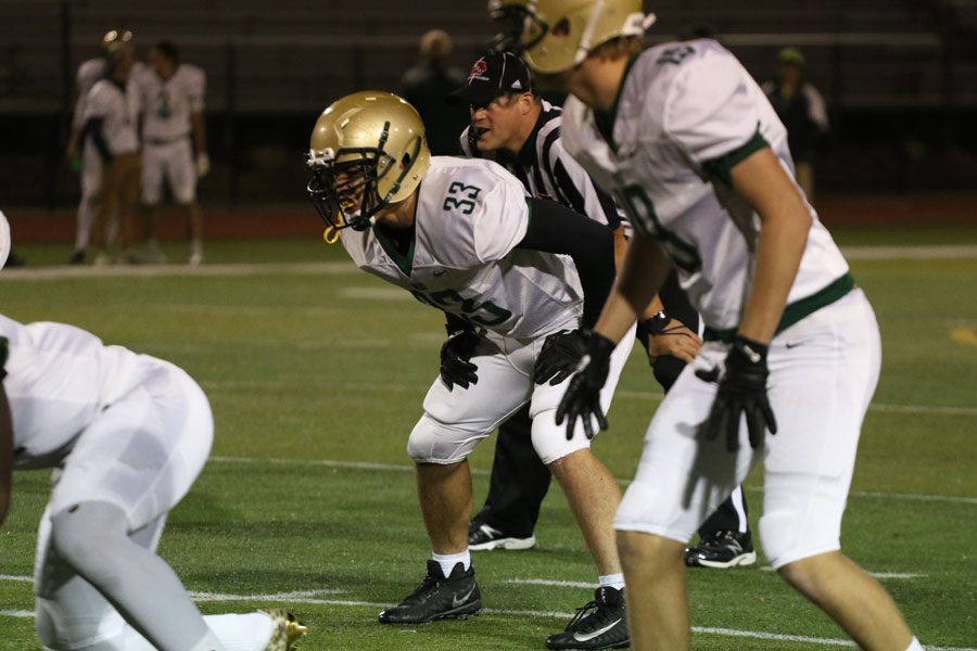 Will Hoeft '20 gets prepared to defend Linn-Mar during the second half on Friday, Sept. 28. As a dual-sport athlete, Hoeft applies his leadership skills differently during football and wrestling season.