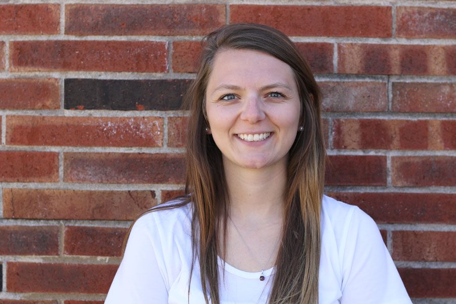 Athletic Secretary Brianna Dusterhoft poses outside West High on Wednesday, Sept. 12.