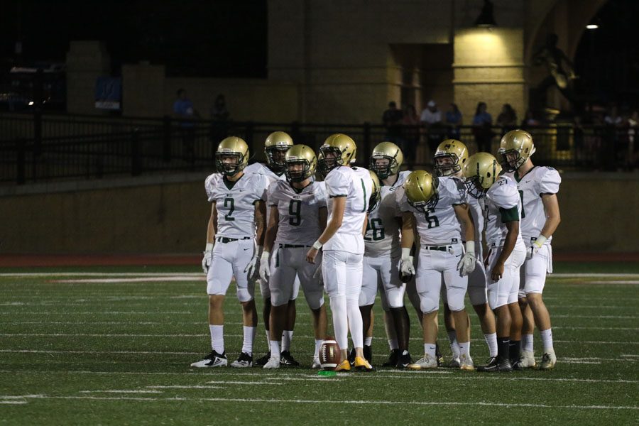 The special teams gather around Josh Jasek 19 before kickoff at the beginning of the game on Friday, Sept. 14.