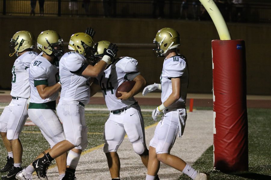 Alex Boxwell '19 celebrates with Landon Green '19 after Green scored a touchdown during the second quarter on Friday, Sept. 14.