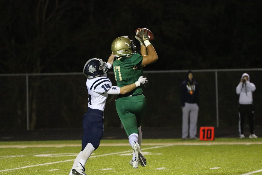 Jalen Gaudet '19 catches a pass to gain a first down for the Trojans during the first half on Friday, Sept. 21.