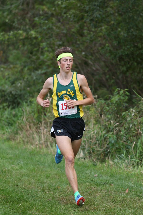 Kolby Greiner '19 runs past the one mile marker during the race on Thursday, Sept. 27. Greiner won the race in a time of 16:03.