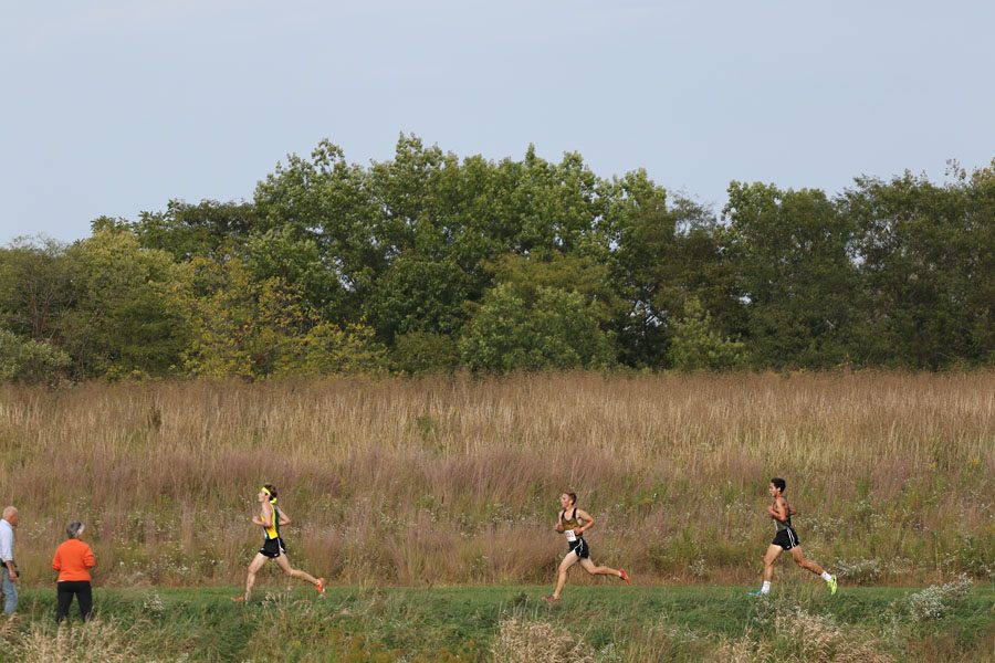 Will Conrad '19 runs by the second mile marker on Thursday, Sept. 27. Conrad placed 13th with a time of 17:05.