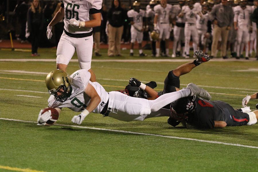 Peter Breitbach '19 dives into the end zone for a touchdown during the first half on Friday, Sept. 28.