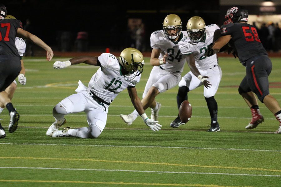 X Lubuelo '19 reaches back to grab the football before a defensive player from Linn-Mar does on Friday, Sept. 28.