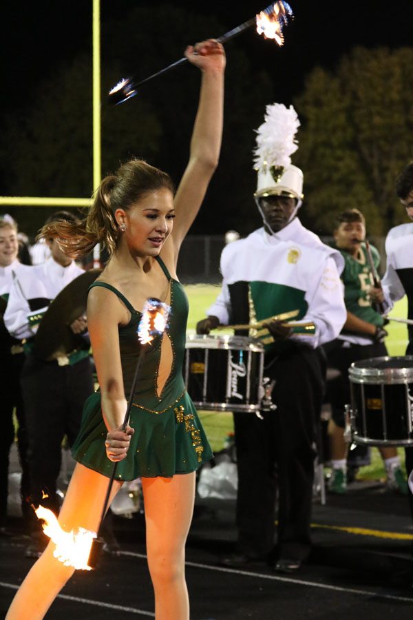 Lizzy Slade '21 performs in front of the student section with her batons on fire on Friday, Oct. 19.