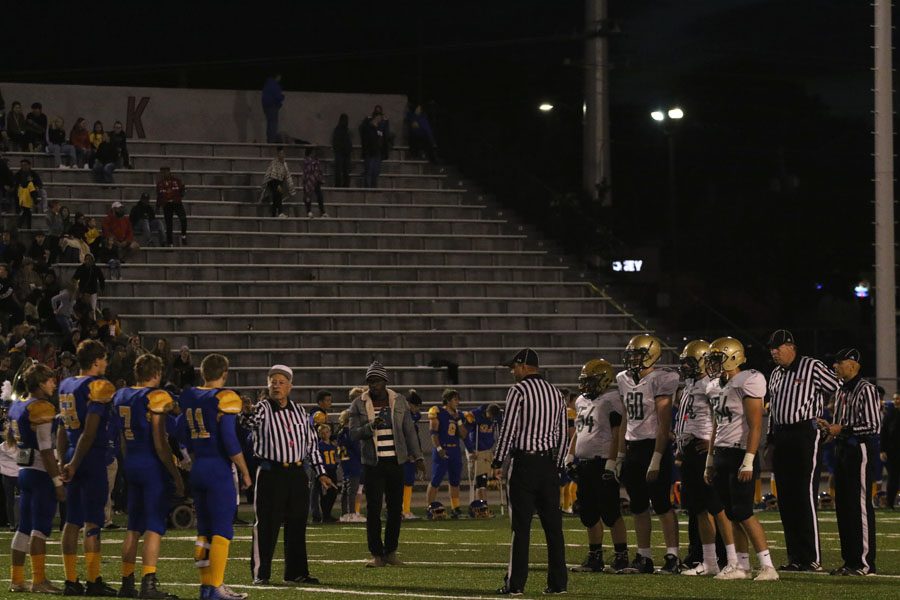 West captains Alex Boxwell '19, Marshall Blatz '19, Cole Mabry '19 and Owen McAreavy '19 stand with the captains from Davenport North for the coin toss at the beginning of the game on Thursday, Oct. 4.