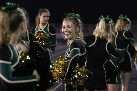 Austyn Goodale 20 stands on the sidelines as she cheers during the first home game against North Scott on Friday, Aug. 24.