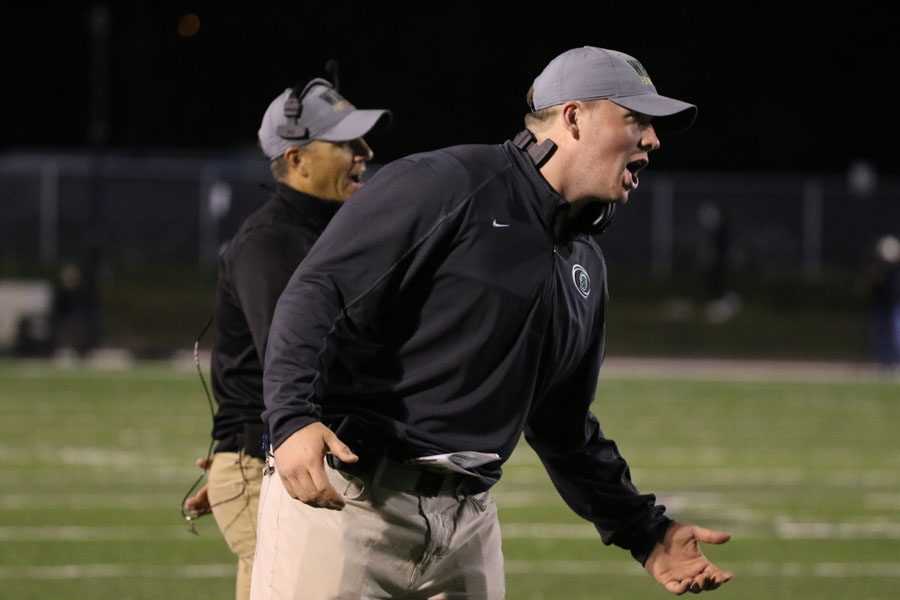 Running back and special teams coach Sam McLeran celebrates after Landon Green ‘19 scored a touchdown on Thursday, Oct. 4. 