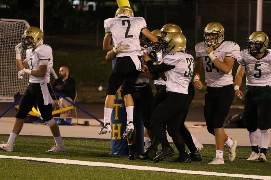 Landon Green '19 picks up Noah Aanestad '19 in celebration after he scored a touchdown on Thursday, Oct. 4.