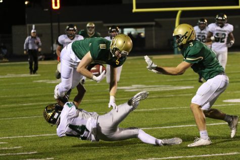 Justin Thomas 19 (3) watches as Tate Crane 20 (10) brings the ball down the field as Cedar Rapids Kennedys Cam Jones 19 trips him up on Oct. 26, 2018. I was running over to block for Tate, so when he went down I went straight to catch him or help him up, Thomas said. Whenever your teammate hits the ground you help them up. Its part of being a team and he would do the same for me.