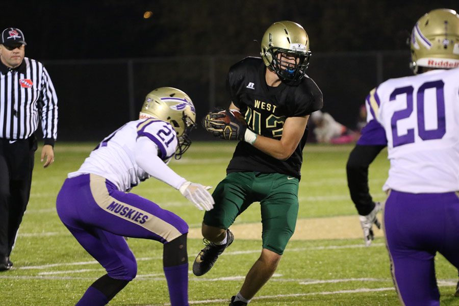 Alex McKay '21 turns around after catching a pass in hopes of getting to the end zone on Friday, Oct. 12.