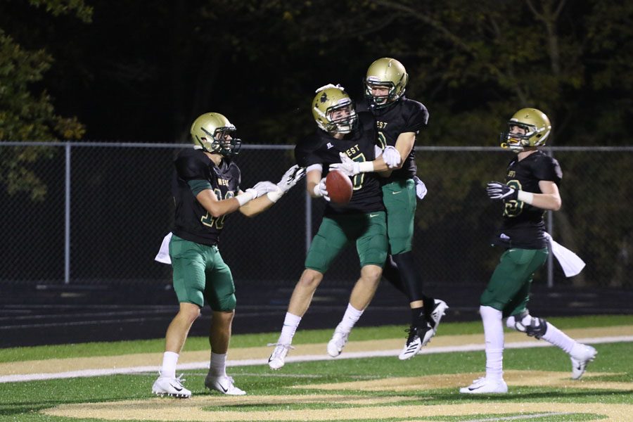 Grant Henderson '20 celebrates with Noah Aanestad '19 after Henderson scored a touchdown during the second half on Friday, Oct. 12.