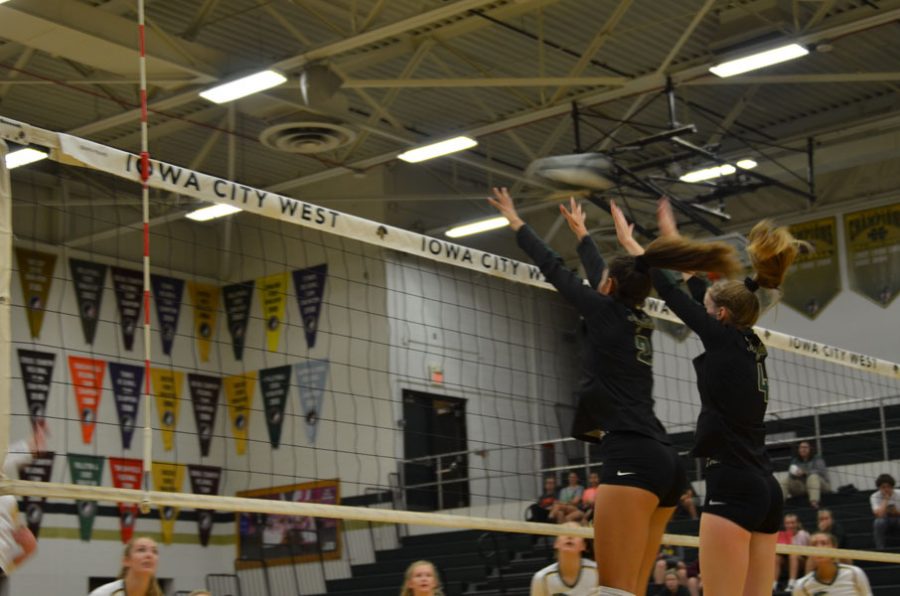 Cailyn Morgan '19 and Claire Overton '19 go up for a block on Tuesday, Oct. 9.