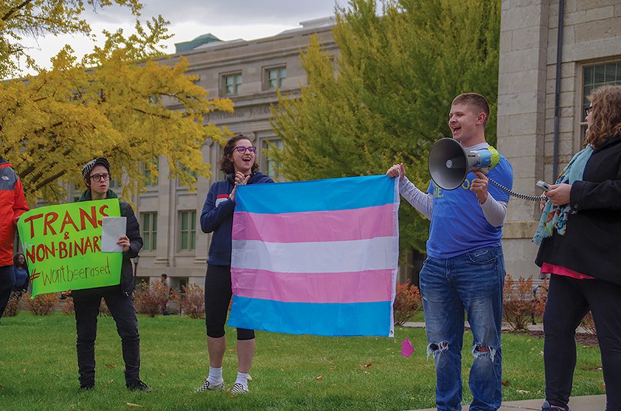 Margo O’Neal cheers on Kyla Peterson after an inspiring speech at a “Support Trans Lives” rally at the Pentacrest on Oct. 25.