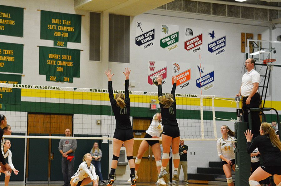 Rylee Fay 20 and Emily Cray 19 jump to block a Kennedy hitter on Wednesday, Oct. 17.