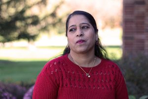 Samina Naz poses for a portrait outside of West High School. Her journey to the United States has not always been an easy one.