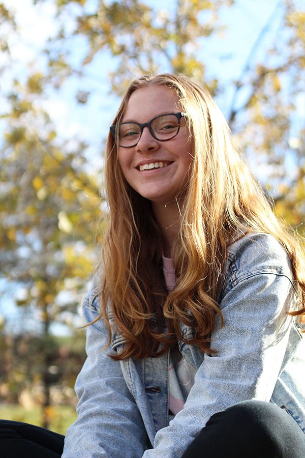 Erin Netolicky 20 smiles while sitting in the West High courtyard.