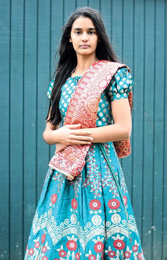 Shreya Khullar 22 wears a traditional Indian lehenga. Lehengas often consist of a colorful blouse and matching skirt paired with a scarf of a complementary color, called a dupatta. 