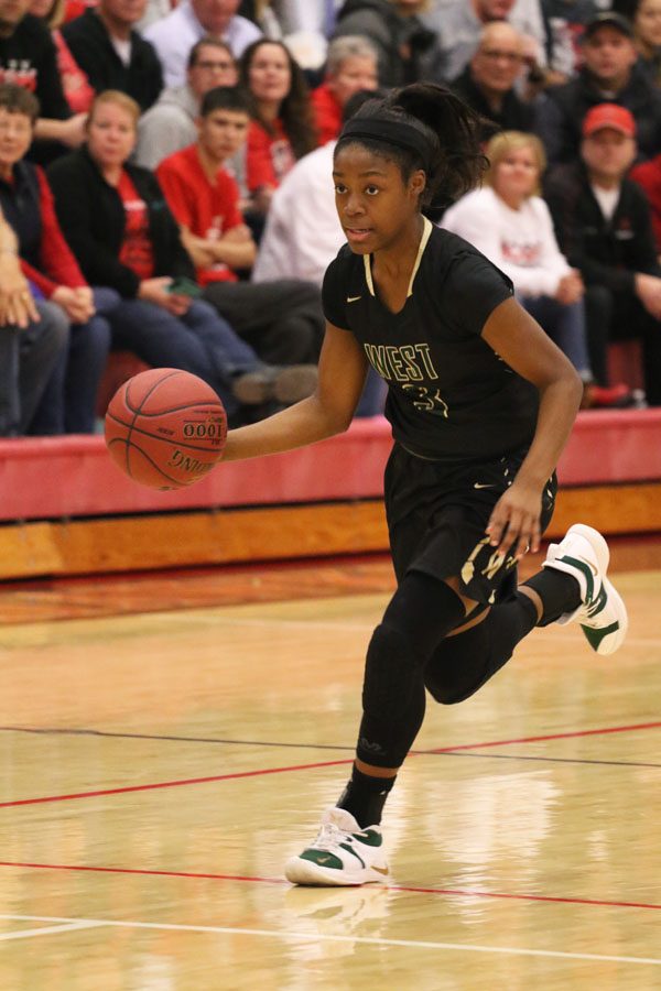 Matayia Tellis '21 dribbles the ball down the court during the second half on Friday, Dec. 7.