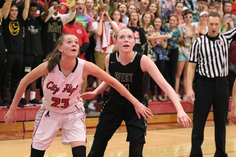 Sydney Allen '19 watches the ball as City High's Aubrey Joens '20 boxes her out during the second half on Friday, Dec. 7.