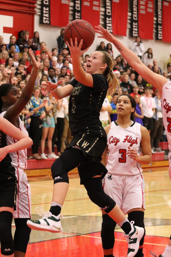 In overtime, Lauren Zacharias '19 scores two points for West as two Little Hawks attempt to block her on Friday, Dec. 7.