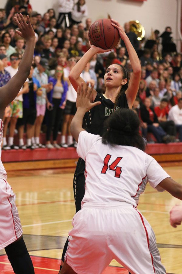 Cailyn Morgan '19 brings the ball up as she shoots during overtime on Friday, Dec. 7.