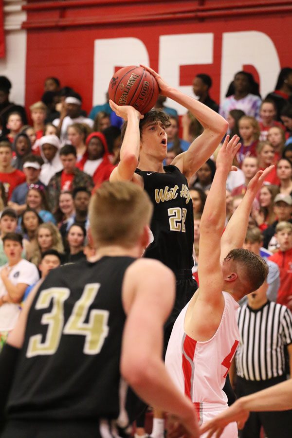 Patrick McCaffery '19 shoots the ball over City High's Liam McComas '19 during the first half on Friday, Dec. 7.