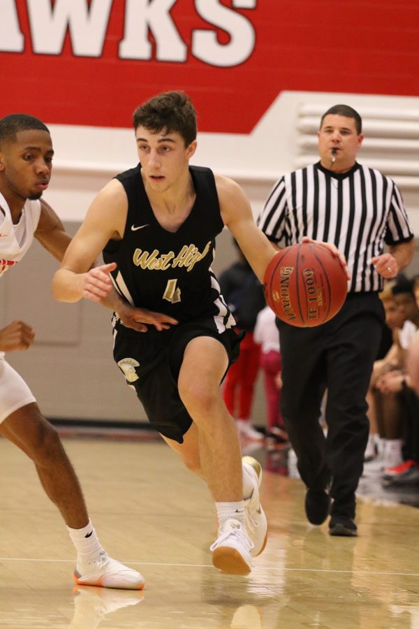 Brayden Adcock '19 tries to dribble around City High's Antonio Turner '19 in order to get to the basket on Friday, Dec. 7.