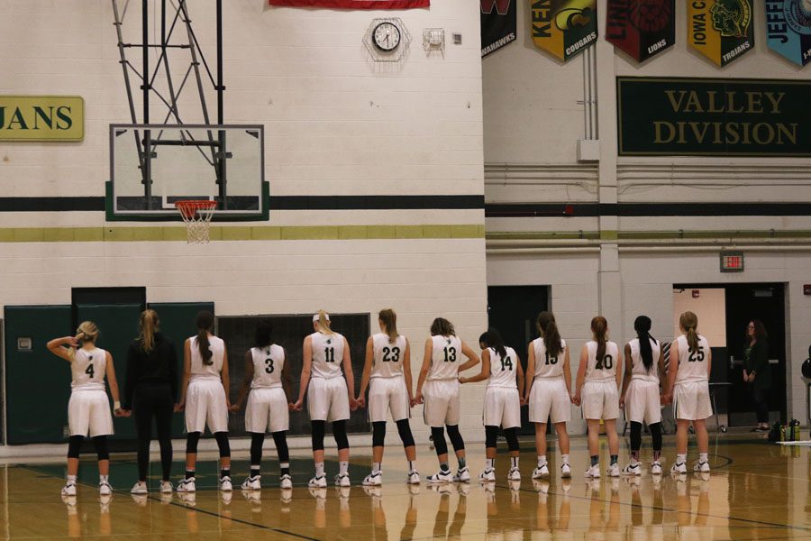 The team stands together for the National Anthem before the game on Friday, Nov. 30.