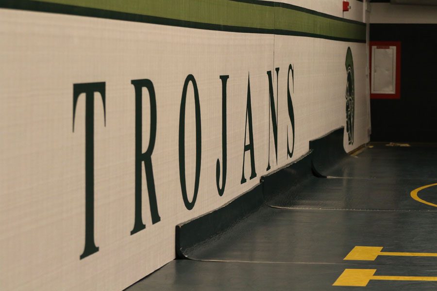 On one side of the new wrestling room a mat that spells out 'Trojans' is hung up on Friday, Nov. 30.