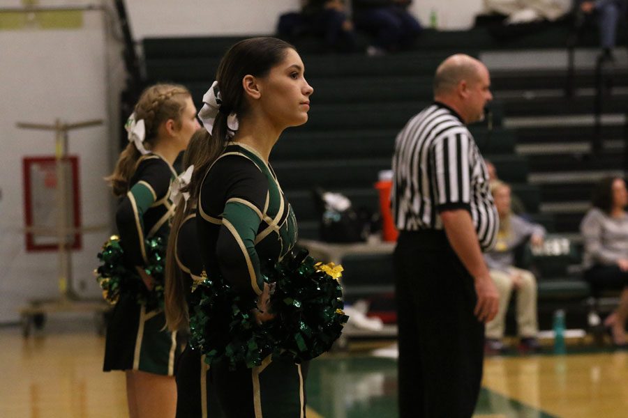 Angela Reis '19, basketball cheer captain, watches the game during the second half on Friday, Nov. 30.