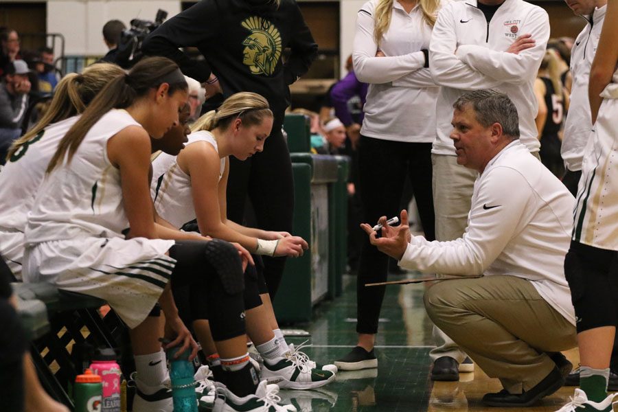 Head coach BJ Mayer talks to the team during a timeout in the second half on Friday, Nov. 30.