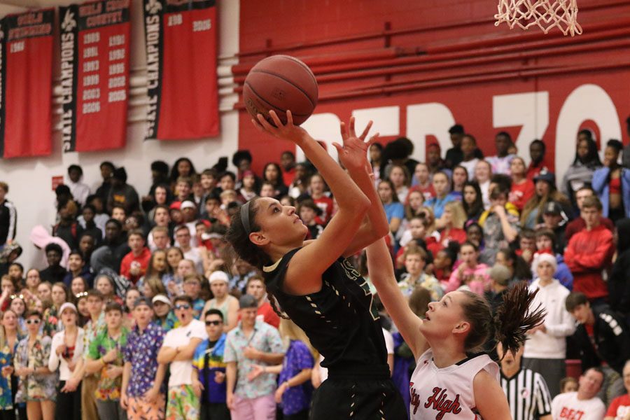 Cailyn Morgan 19 goes up for a layup as City Highs Aubrey Joens 20 tries to block her during the first half on Friday, Dec. 7.