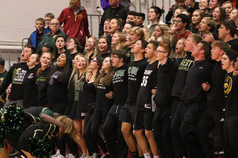 The student section cheers as West battles against City High on Friday, Dec. 7.