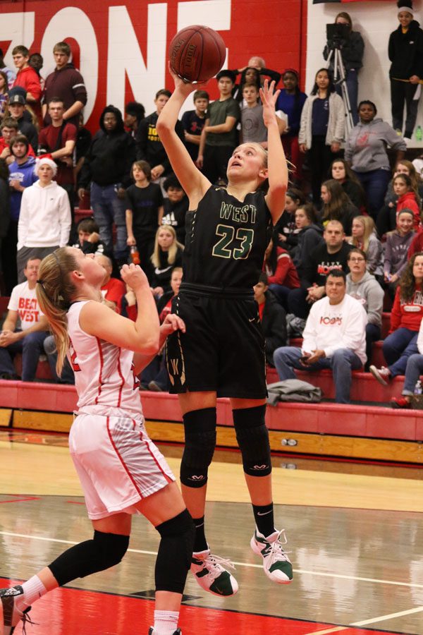Audrey Koch 21 jumps up to score two points for West during the first half on Friday, Dec. 7.