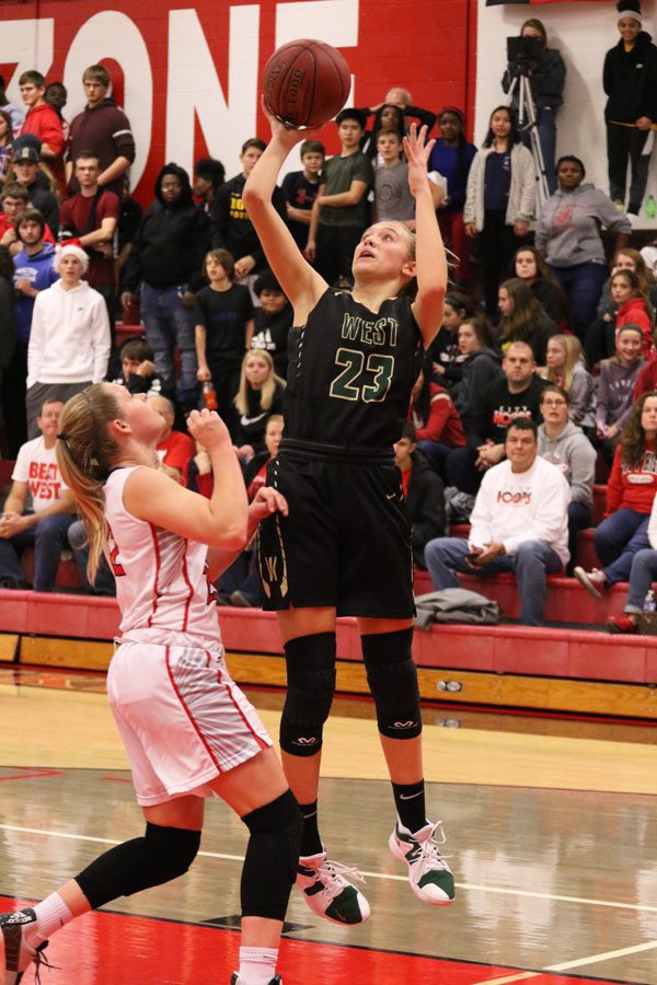 Audrey Koch '21 jumps up to score two points for West during the first half on Friday, Dec. 7.