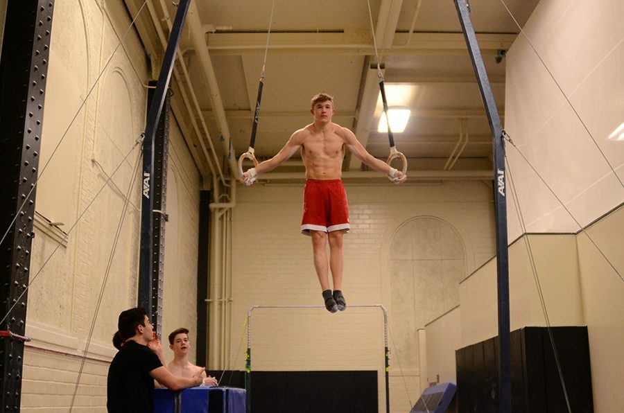 Zack Gilbaugh '21 does a half T-position on the rings while mentally preparing himself to dismount by a flip.