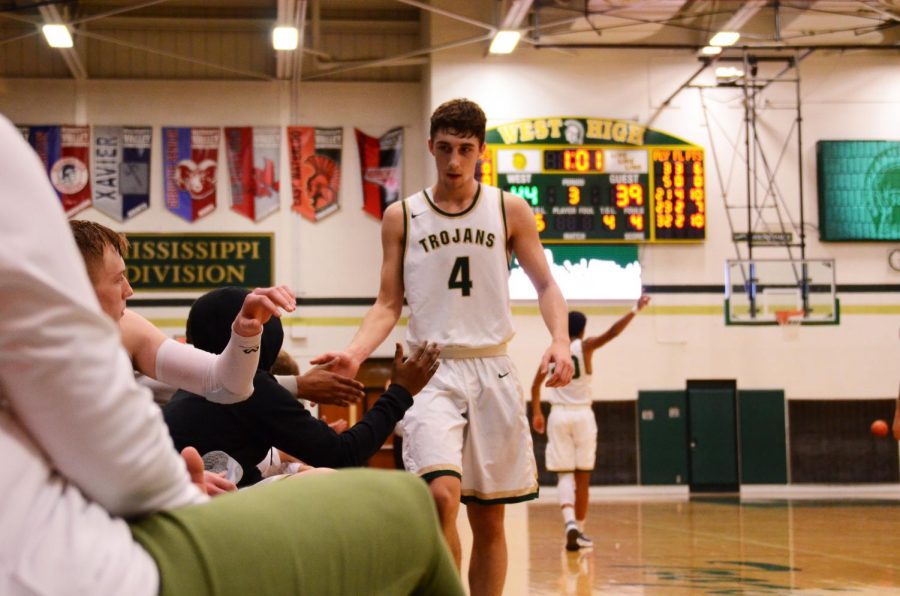 The bench high fives Brayden Adcock '19 after being subbed out in the third quarter on Saturday, Dec. 1.