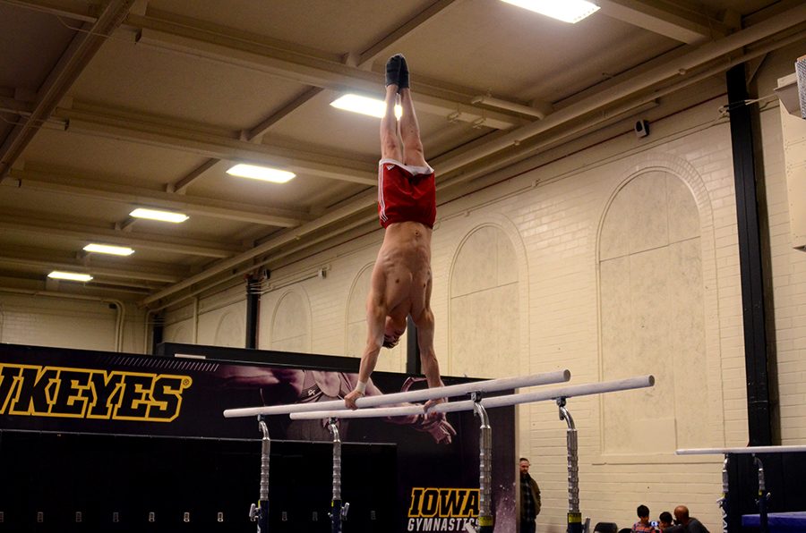 Zach Gilbaugh '21 does a handstand on the even bars. 