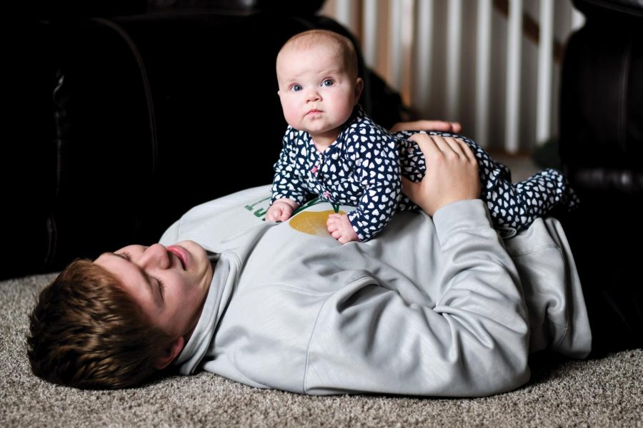 Noah Breitbach 19 holds Stella after playing with her on the floor. He says that, She just makes us laugh all the time.