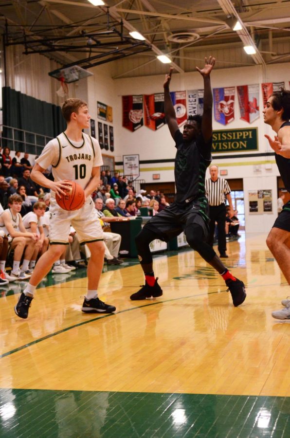 Tate Crane '20 looks for another player to pass to while being guarded by two opposing players on Saturday, Dec. 1.