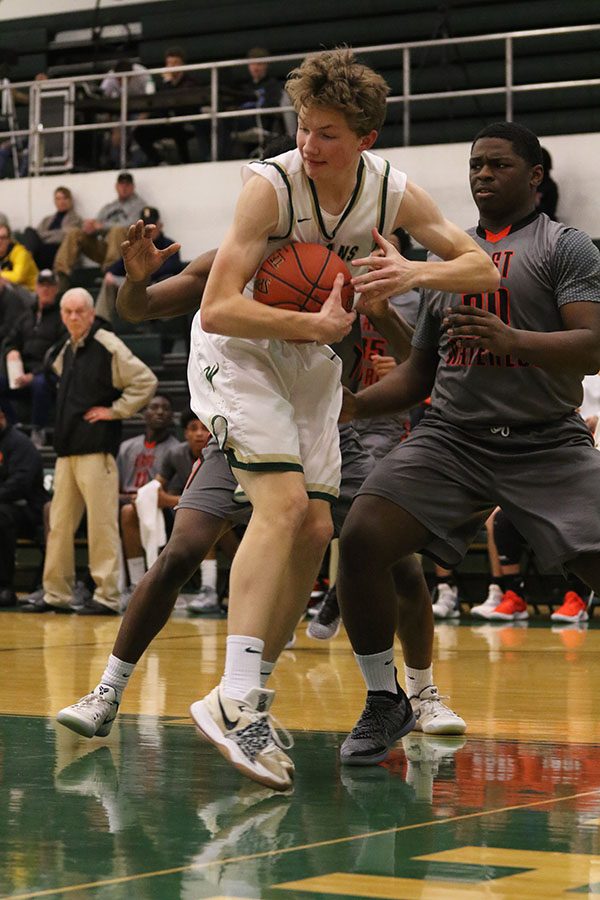 Ben Vander Leest 20 saves the ball from going out of bounds during the first half on Tuesday, Jan. 15. V