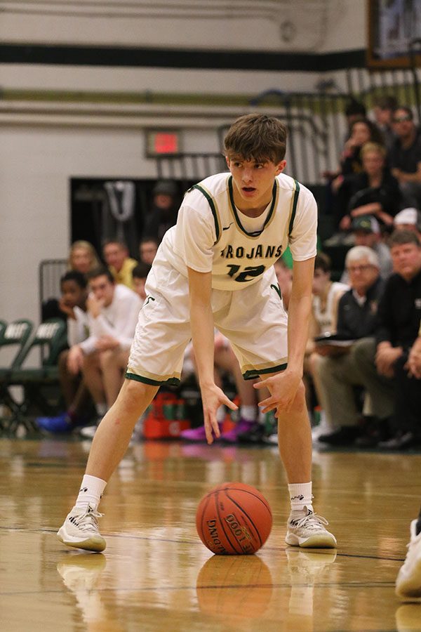 Joey Goodman 20 dribbles the ball back and forth between his hands as he waits for the clock to count down during the first half on Friday, Jan. 4.