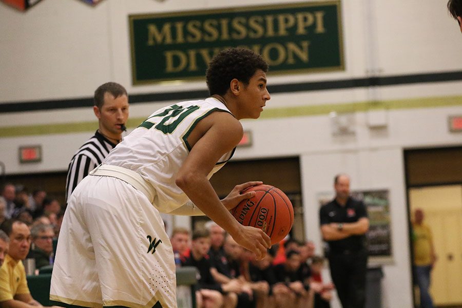 Marcus Morgan '21 dribbles the ball as he waits for a fellow Trojan to be open during the second half of the game on Friday, Jan. 4.