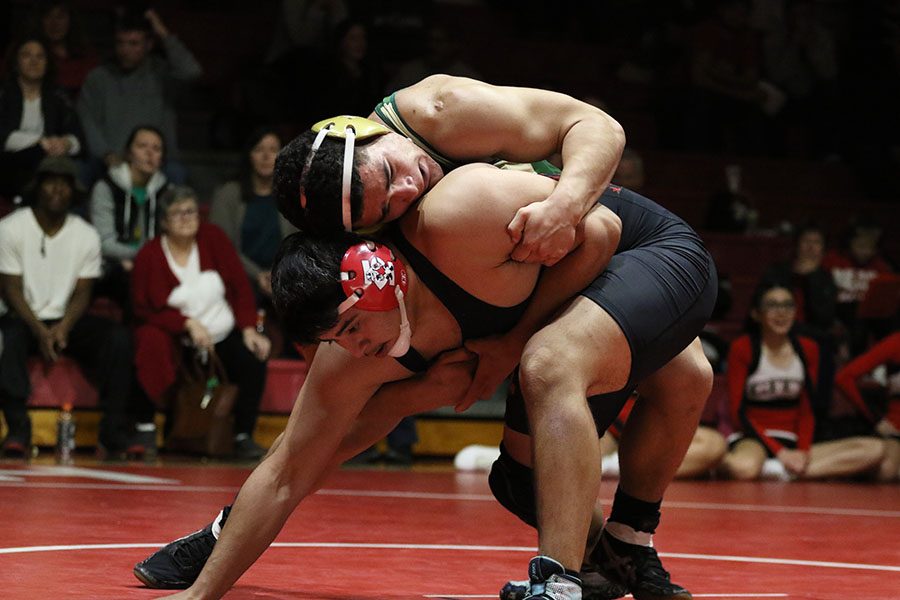 Landon Green 19 tries to take City Highs Jason Lemus 20 down on Thursday, Jan. 3. Green won by major decision.