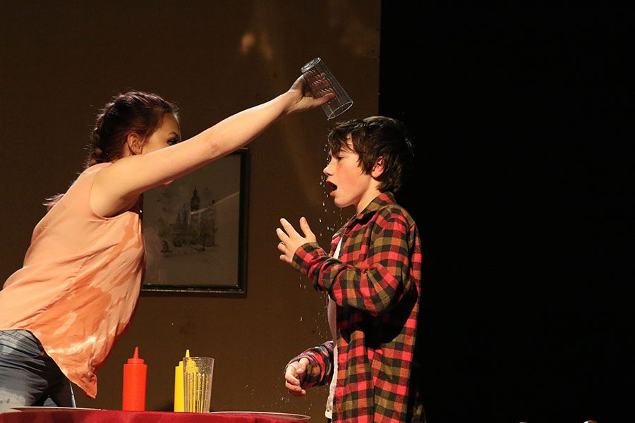 Willa Martin '21 pours a glass filled with water on Gus Elwell '22 during the comedy play "It's not you, it's me" on Thursday, Jan. 10.