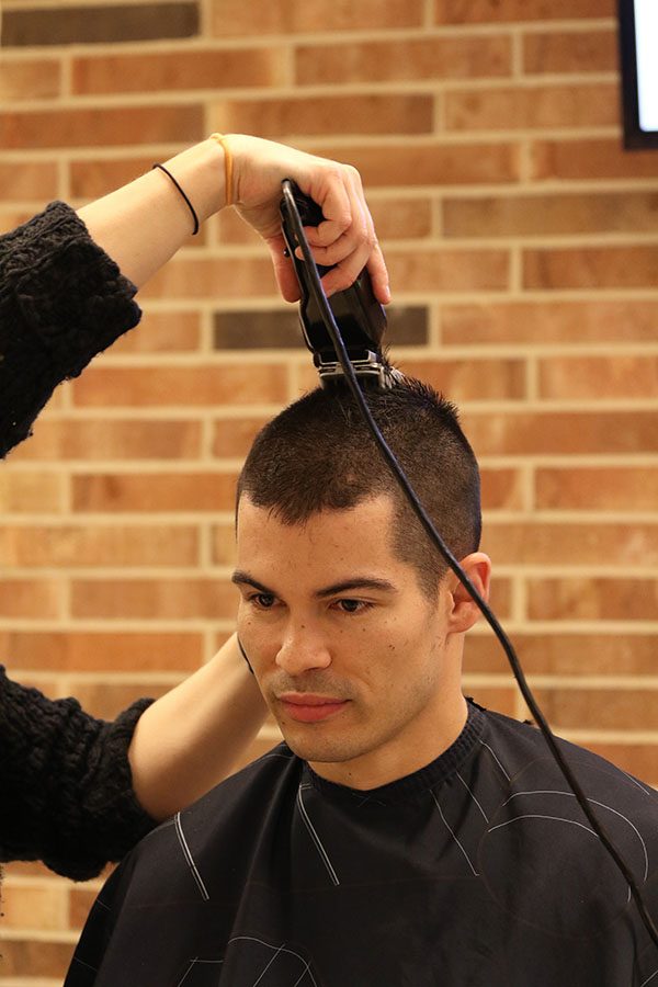 In a spur of the moment decision, math teacher Greg Witt shaves his head during seventh hour on Friday, Jan. 11.